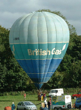 Balloon photographed ready to launch, has a light blue horizontal band at the top, then a darker blue band with British Gas logo, then a darker blue band