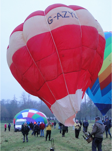 Red balloon with a yellow horizontal stripe and base.