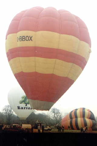 Balloon ready to launch, is red with two yellow horizontal bands