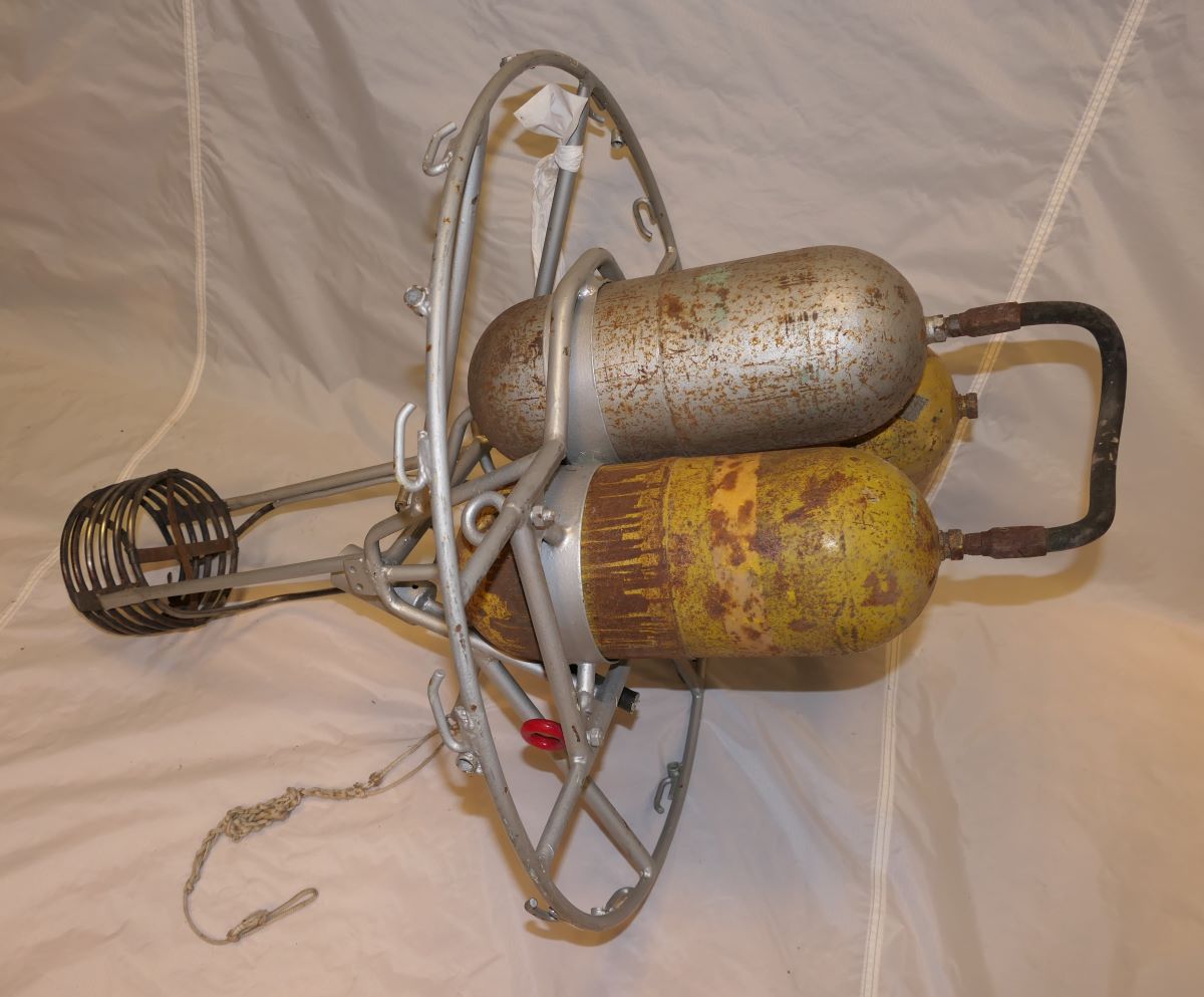 Side view of the burner - the burner protrudes one side of the circular frame and the cylinders the other side. The image shows the fixings for the balloon mouth to the frame.
