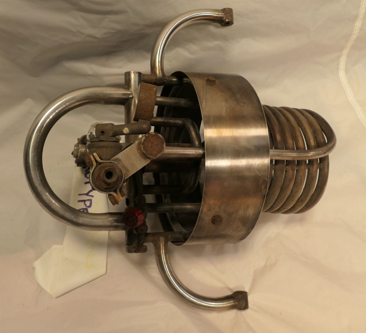 Side view of the burner showing the shroud, the fixings to a frame and the coil.