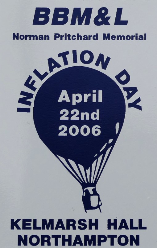 White background to sticker with a navy silhouette of a balloon in the centre and event date across the balloon. At foot of sticker is the location. At top of sticker is the title Norman Pritchard Memorial.