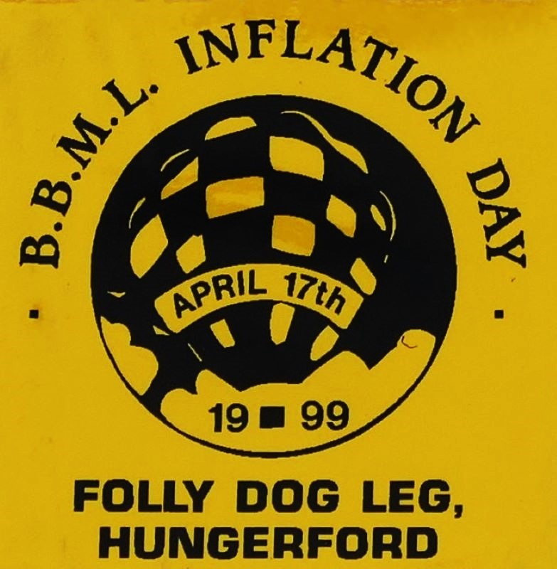 Yellow background to sticker with a black silhouette of a balloon in a circular background in the centre and event date across the balloon. At foot of sticker is the location.