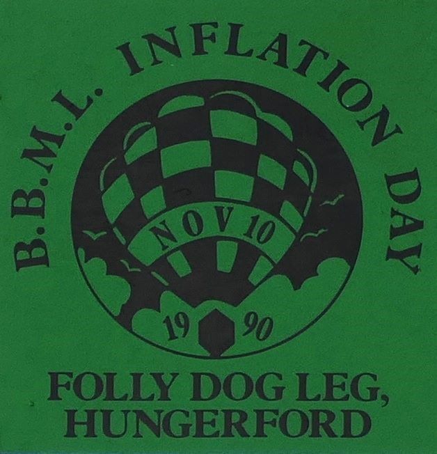 Green background to sticker with a black silhouette of a balloon in a circular background in the centre and event date across the balloon. At foot of sticker is the location.
