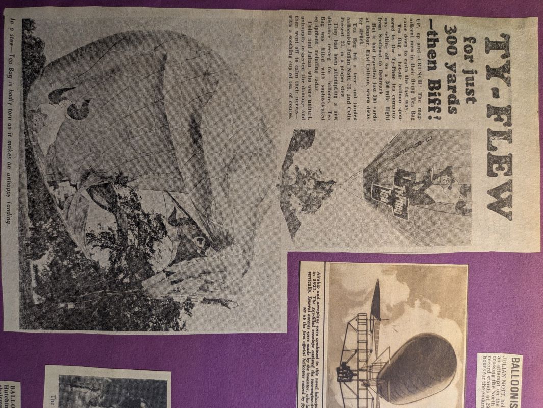 Picture of scrap book page showing newspaper article about ill-fated attempt to cross the North Sea with an image of the balloon snagged on a tree.