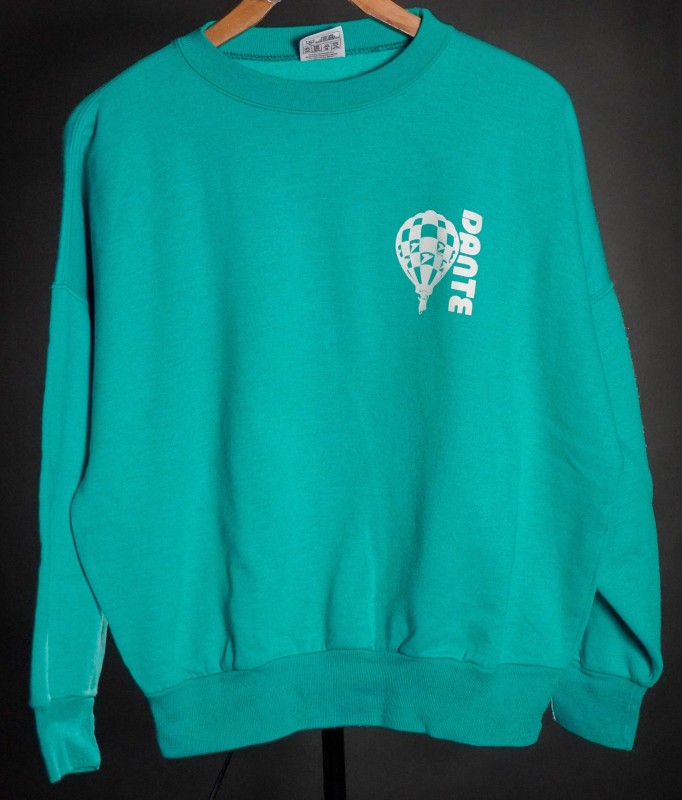 Turquoise sweatshirt with white and turquoise checkered Dante balloon on left chest and Dante in vertical white text to the right of the balloon. 