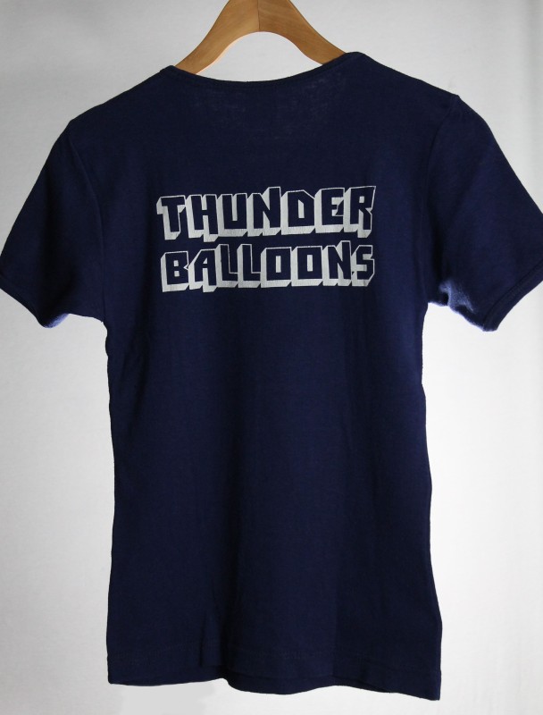 On the back of the T-shirt is the company name in 3D capital letters outlined in white.