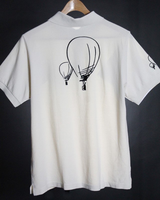 Back of polo shirt with outline drawing of two balloons in black, one large and one small. Same drawing of 2 balloons on right sleeve.
