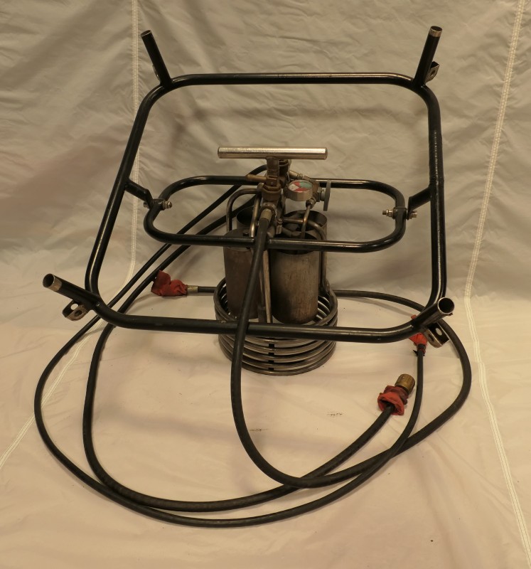 Image of the underside of the burner and frame, showing the pressure gauge, gas inlet control valve and the gimbal handle.