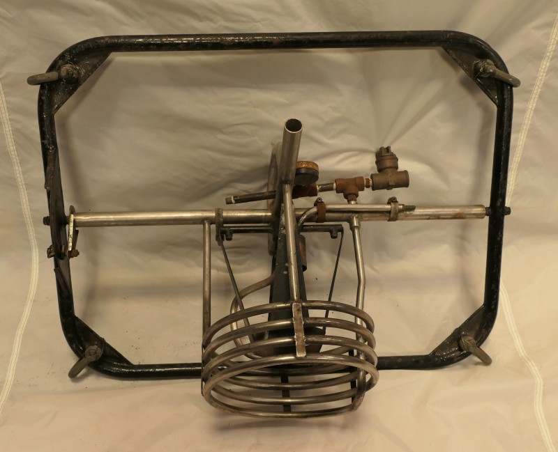 A single burner in a black metal frame, no fuel hoses are attached. The corners of the frame have the shackles for the flying wires.   