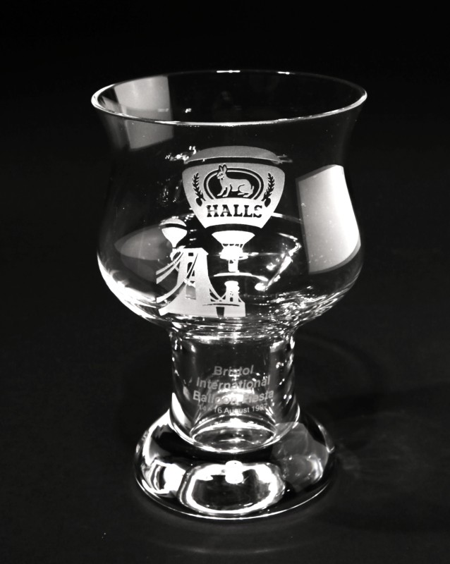 Glass goblet engraved with image of the Halls balloon, featuring their hare, and the Clifton Suspension Bridge. Event name and date on stem of the glass.