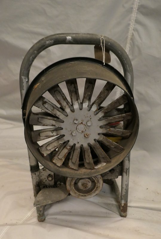 Open fan on a stand, no cage but there is a shroud around the edge of the fan. Handle across the top to manoeuvre the fan. 