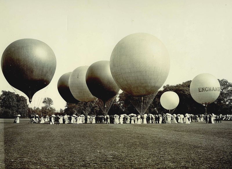 Black & White image of seven gas balloons inflated on the ground in Ranelagh Gardens, London Circa 1905 with a large number of smartly dressed onlookers.
