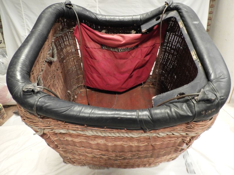 View looking down into the basket from the long edge. The instrument panel has been removed to reveal more of the basket and the Thunder Balloons red fabric bag with pockets.