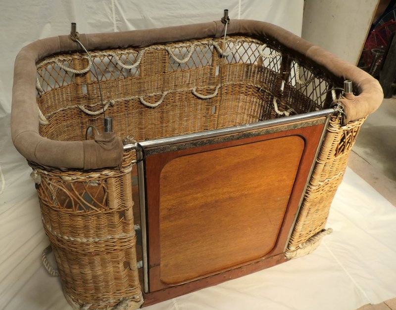  Wicker basket, last 6 inches has open weave to allow wheelchair passengers to see. One long side of basket has metal framed wooden door, hinged at the base to create a ramp for easy access. There are 2 rows of rope grab handles for passengers.       