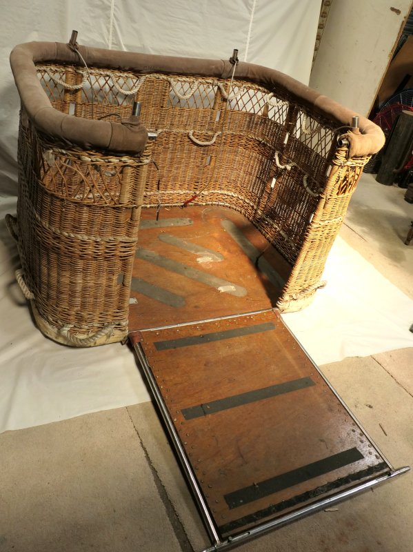 View of basket with door open to create a ramp. Wooden floor of basket and ramp has non-slip strips.