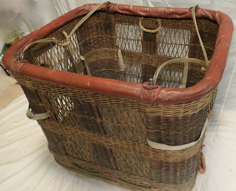 View looking slightly down into the basket, showing the 4 grab handles, 1 per side, and the tank straps in the corners.    