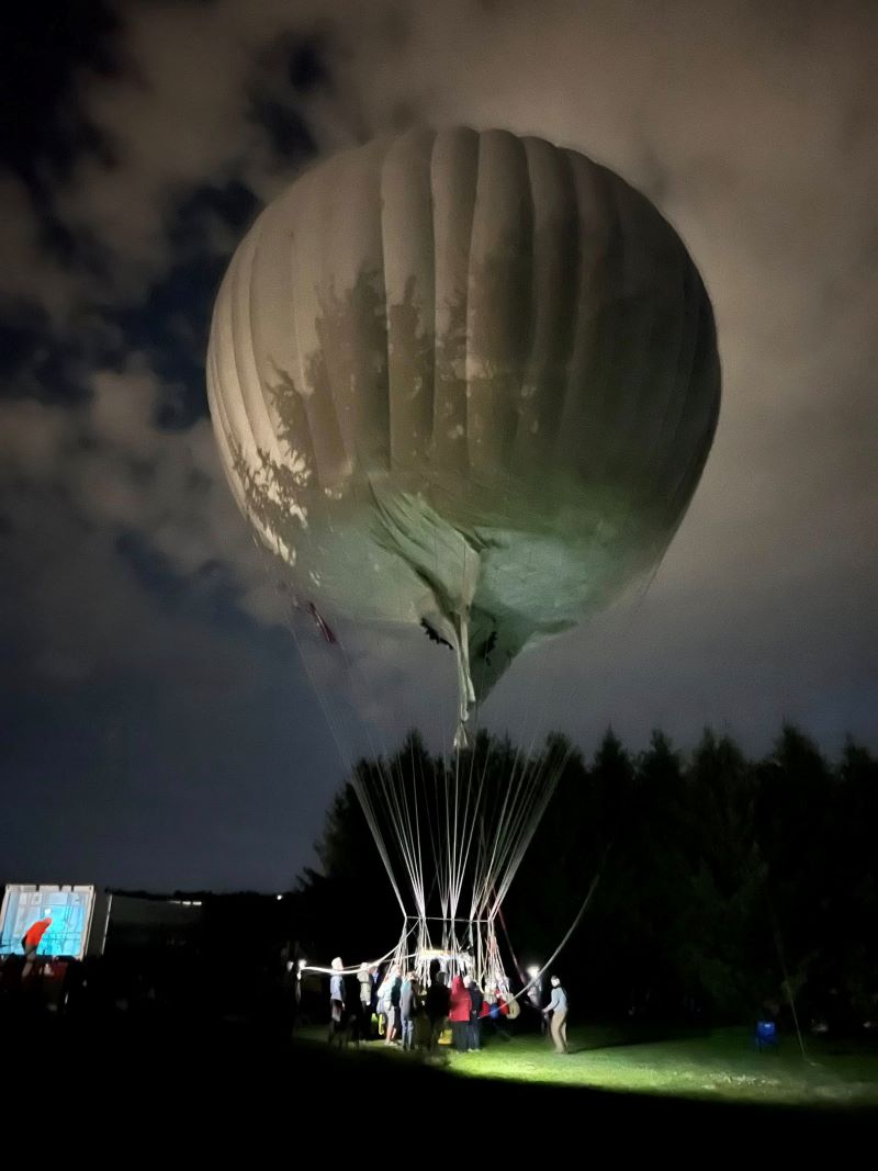 Picture of gas balloon inflated against the night sky . Credit Dawn Honey Chase